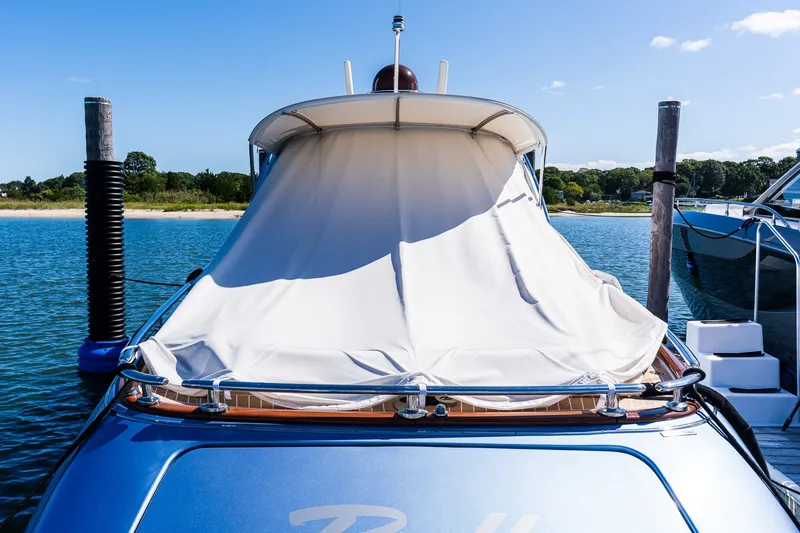 Slide: The Image of 2014 Zeelander Z44 yacht docked with cover, under clear blue sky. - 10