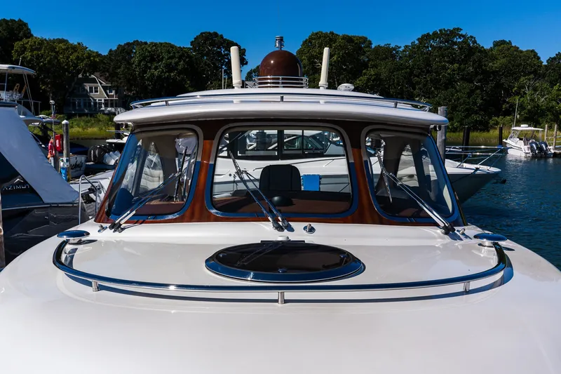 Slide: The Image of 2014 Zeelander Z44 yacht docked, showcasing sleek design and luxurious features. - 14