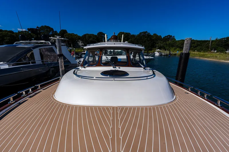 Slide: The Image of 2014 Zeelander Z44 yacht with sleek deck design, docked in a serene marina. - 8