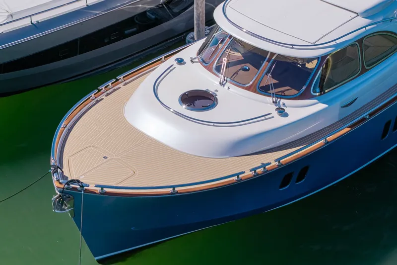 Slide: The Image of 2014 Zeelander Z44 luxury yacht with sleek design and wooden deck, docked in marina. - 9