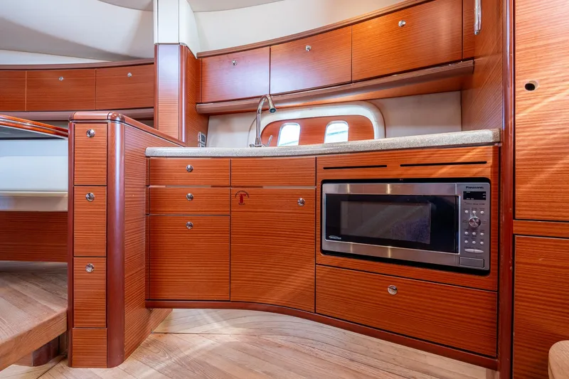 Slide: The Image of Luxurious 2014 Zeelander Z44 yacht interior with modern kitchen and wooden cabinetry. - 46