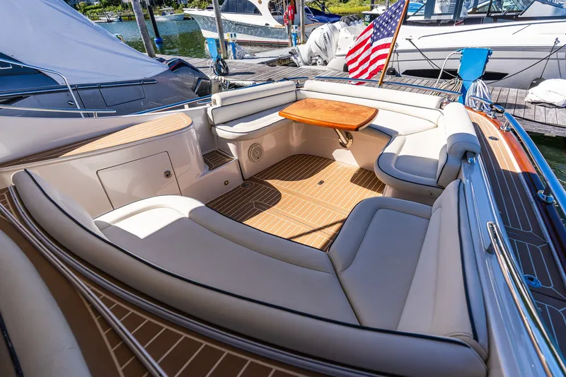 Slide: The Image of Luxurious 2014 Zeelander Z44 yacht with elegant seating and wooden table, docked at marina. - 24