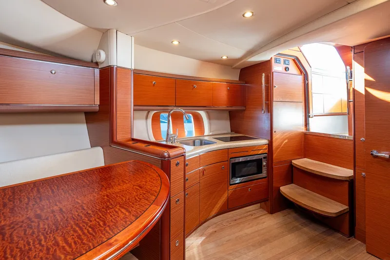Slide: The Image of Luxurious 2014 Zeelander Z44 yacht interior with elegant wood finish and modern kitchen amenities. - 53