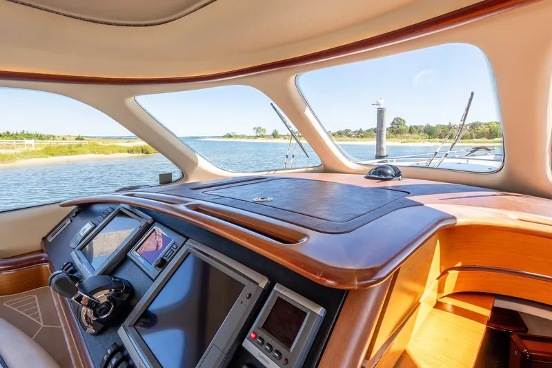 Slide: The Image of Interior view of 2014 Zeelander Z44 yacht helm with navigation screens and scenic waterway. - 36