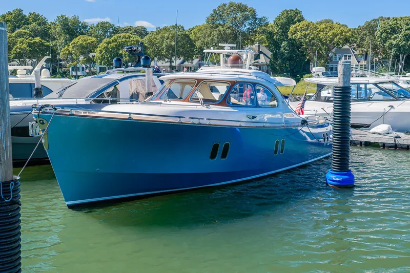 Slide: The Image of Luxurious 2014 Zeelander Z44 yacht docked in a serene marina setting. - 2