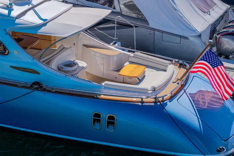 Slide: The Image of 2014 Zeelander Z44 yacht with American flag, featuring sleek design and luxurious seating. - 5