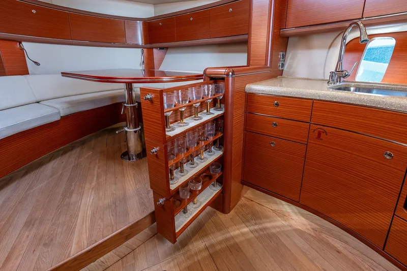 Slide: The Image of Luxurious 2014 Zeelander Z44 yacht interior with elegant wood cabinetry and built-in glass storage. - 50