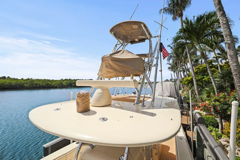 Slide: The Image of 2013 Bahama 41 yacht docked by tropical palm trees and calm water. - 38
