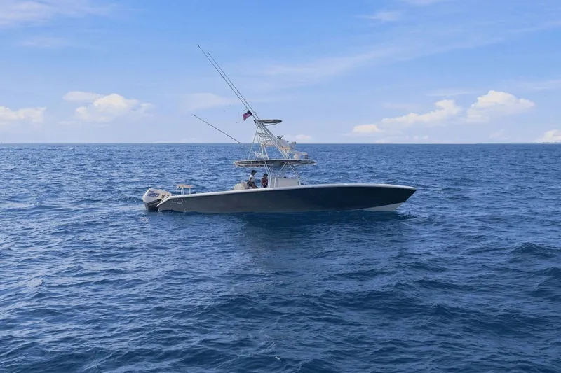 Slide: The Image of 2013 Bahama 41 boat cruising on open ocean under clear blue sky. - 8
