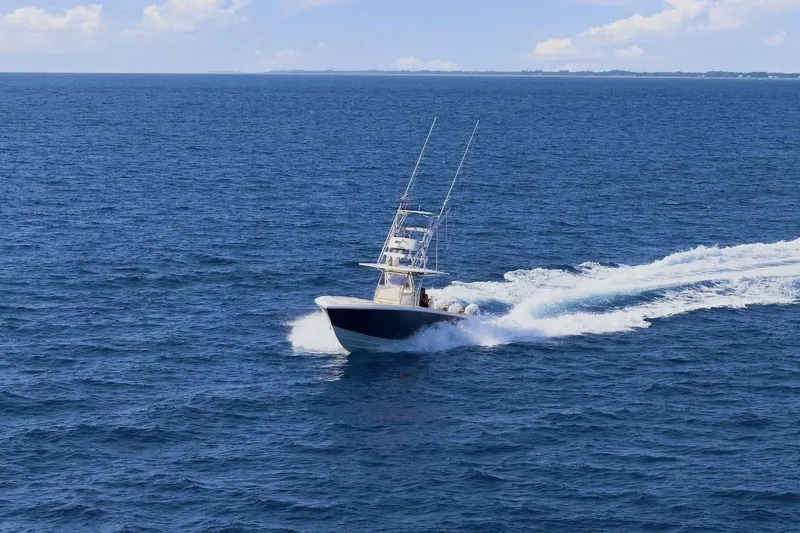 Slide: The Image of A 2013 Bahama 41 boat speeds across the open sea, leaving a white wake behind. - 5