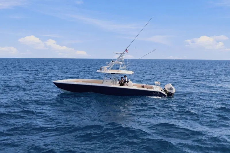 Slide: The Image of A 2013 Bahama 41 boat cruising on open sea under a blue sky. - 4