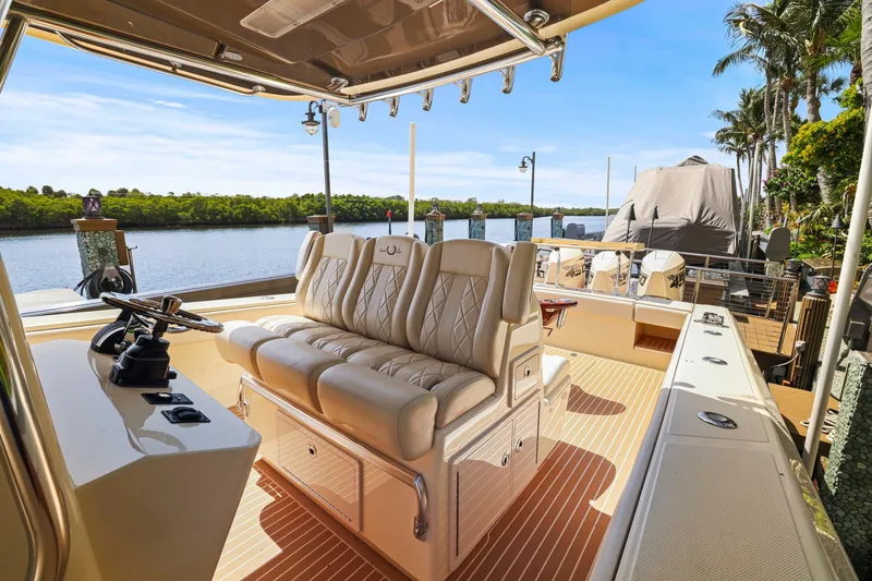 Slide: The Image of Luxurious 2013 Bahama 41 boat interior with plush seating, docked by a scenic waterfront. - 19