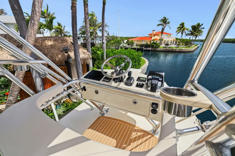 Slide: The Image of Helm of 2013 Bahama 41 boat with scenic waterfront view and palm trees. - 41