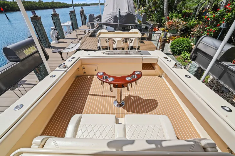 Slide: The Image of Luxurious 2013 Bahama 41 boat deck with seating and fishing rod holders. - 31
