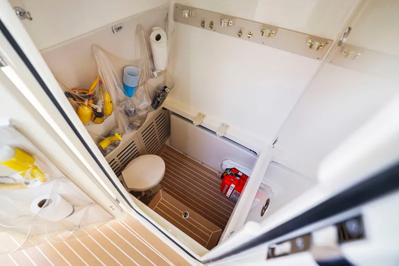 Slide: The Image of Interior of a 2013 Bahama 41 boat bathroom with storage and supplies. - 30