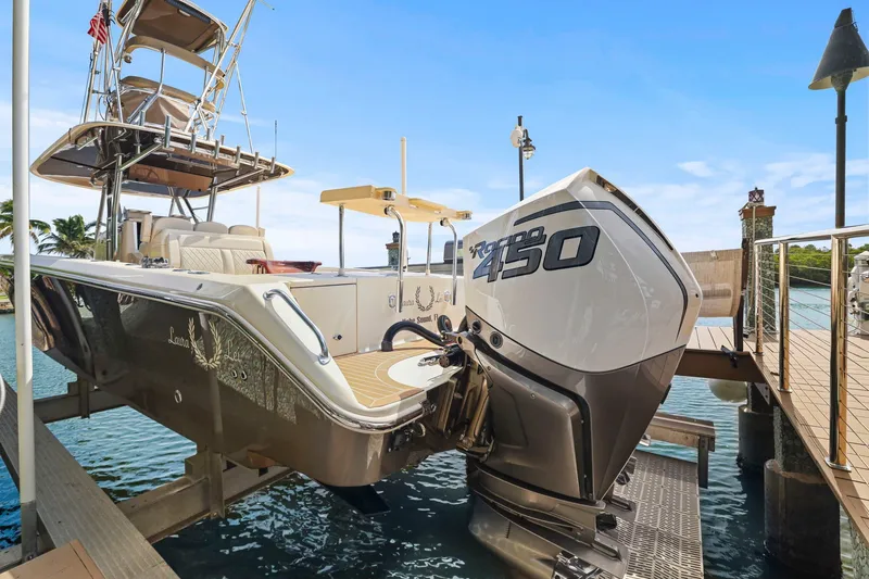 Slide: The Image of 2013 Bahama 41 boat with powerful 450 engine docked by the water. - 33