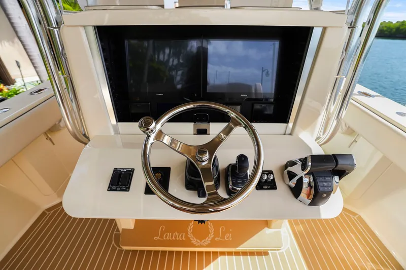 Slide: The Image of Steering console of a 2013 Bahama 41 boat with modern controls and displays. - 23