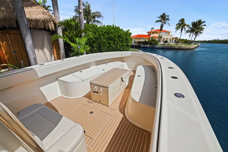 Slide: The Image of 2013 Bahama 41 boat with spacious deck, docked near tropical waterfront property. - 15