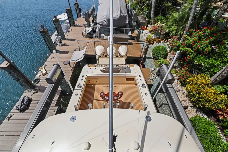 Slide: The Image of Overhead view of a 2013 Bahama 41 boat docked near lush greenery and clear water. - 36