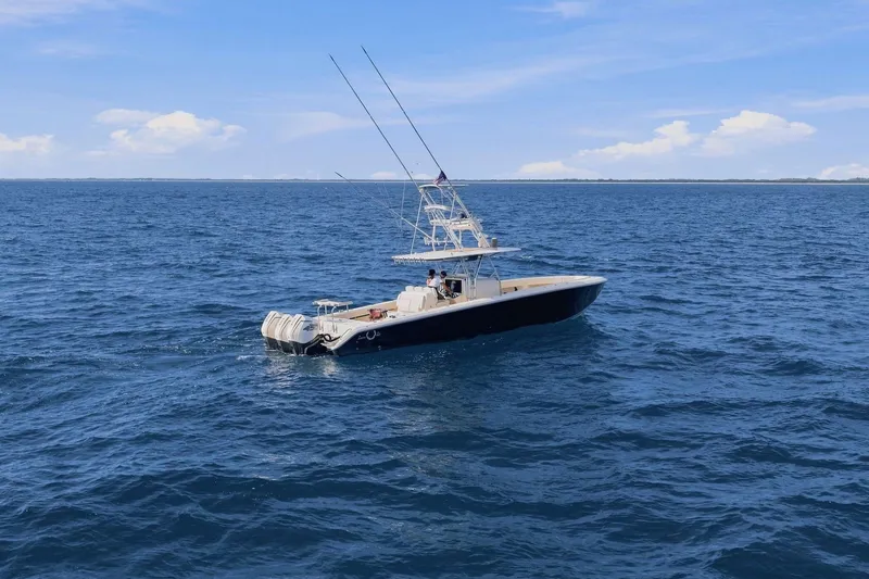 Slide: The Image of 2013 Bahama 41 boat on open ocean under clear blue sky. - 9