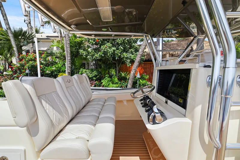 Slide: The Image of Luxurious interior of a 2013 Bahama 41 boat with plush seating and modern controls. - 20