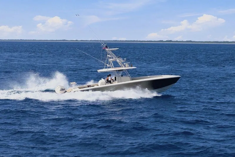 Slide: The Image of A 2013 Bahama 41 boat speeds across the blue sea under a clear sky. - 10