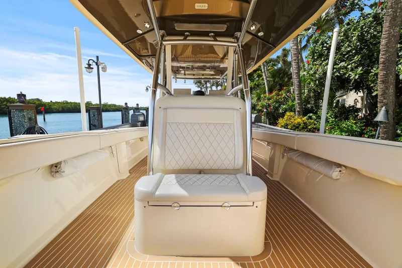 Slide: The Image of 2013 Bahama 41 boat interior with cushioned seating and scenic waterfront view. - 16