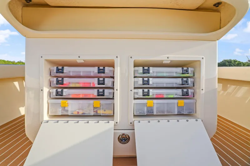 Slide: The Image of Storage compartments with tackle boxes on a 2013 Bahama 41 boat deck. - 29