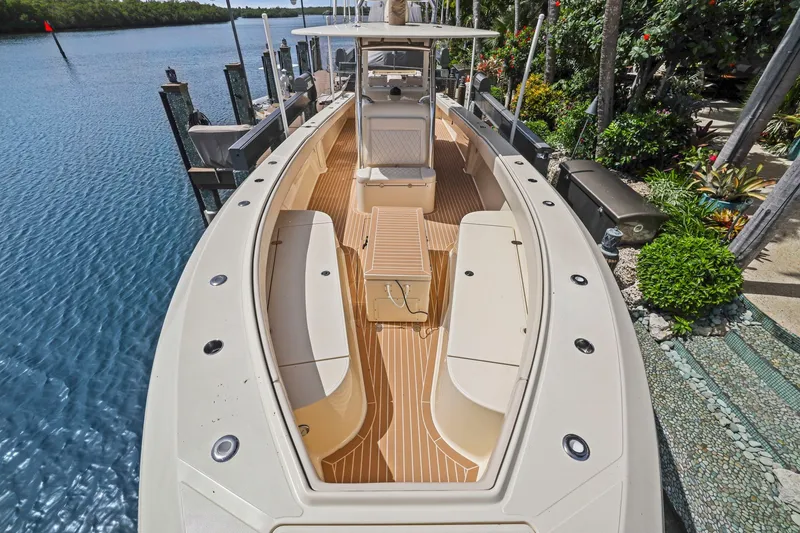 Slide: The Image of 2013 Bahama 41 boat docked by lush greenery and calm waters. - 12