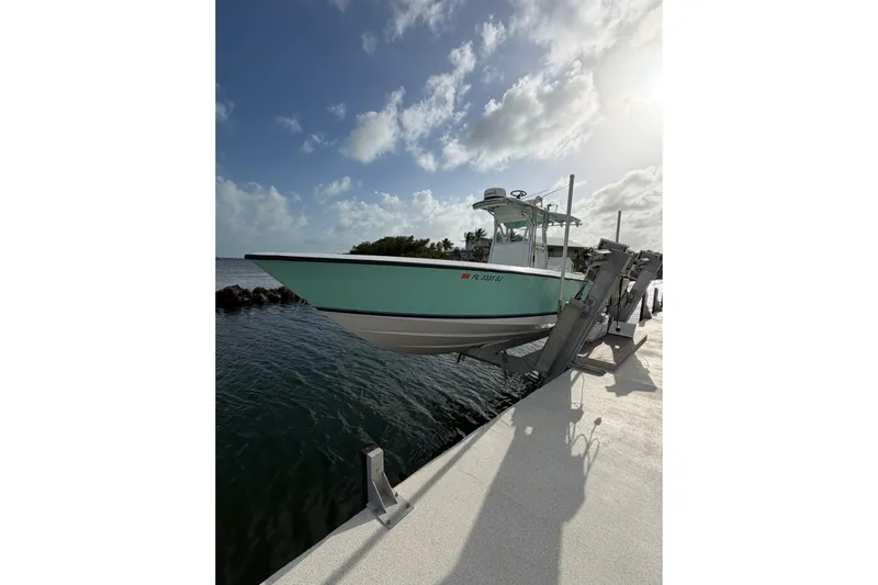 Slide: The Image of 2014 Contender 32 ST boat docked by the water under a sunny sky. - 4