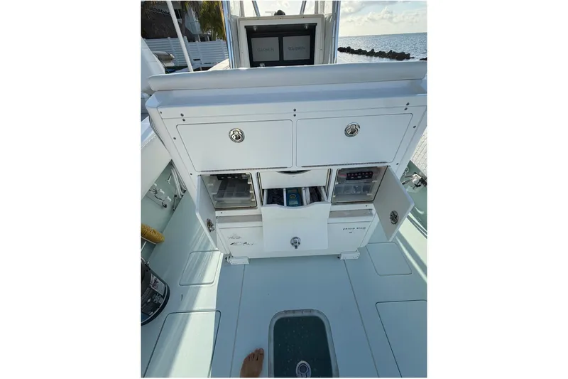 Slide: The Image of 2014 Contender 32 ST boat interior with storage compartments and Garmin navigation system. - 7