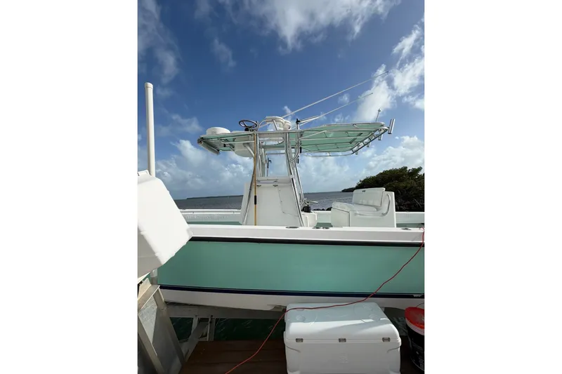 Slide: The Image of 2014 Contender 32 ST boat docked, featuring a center console and clear blue sky. - 5