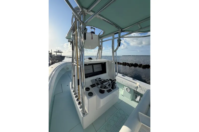 Slide: The Image of 2014 Contender 32 ST boat interior with steering console, ocean view. - 2