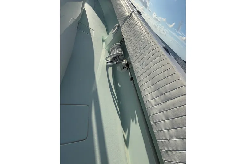 Slide: The Image of 2014 Contender 32 ST boat interior with coiled rope and cushioned seating. - 3