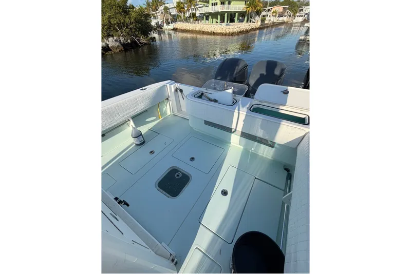 Slide: The Image of 2014 Contender 32 ST boat deck with storage compartments and dual engines. - 9