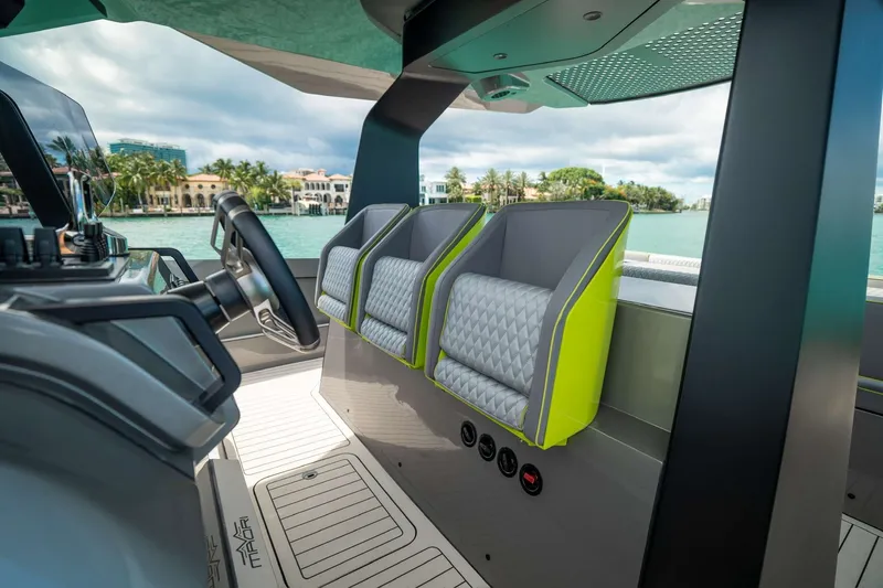 Slide: The Image of Interior of 2024 Maori 46ft boat with modern seating and steering wheel. - 21