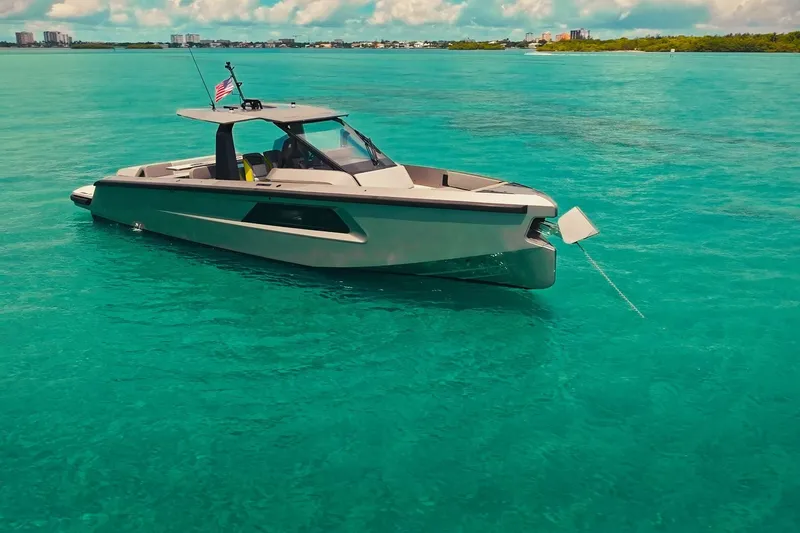 Slide: The Image of 2024 Maori 46ft yacht anchored in clear turquoise waters under a sunny sky. - 16