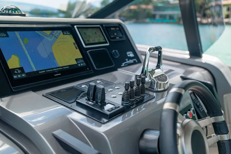Slide: The Image of Control panel of a 2024 Maori 46ft yacht with navigation display and steering wheel. - 20