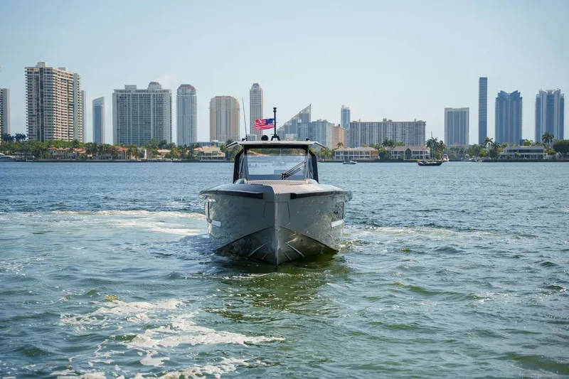 Slide: The Image of 2024 Maori 46ft yacht cruising near city skyline on a sunny day. - 45