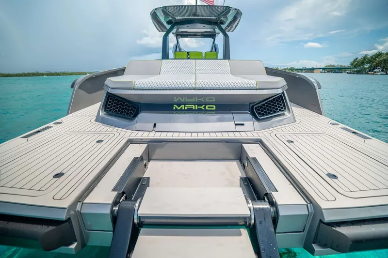 Slide: The Image of 2024 Maori 46ft yacht with sleek deck design and modern seating on turquoise water. - 34