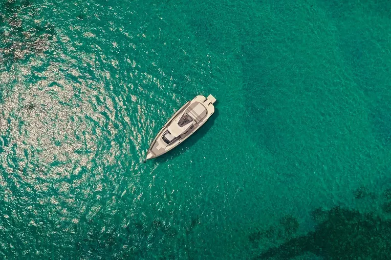 Slide: The Image of Aerial view of 2024 Maori 46ft yacht on clear turquoise water. - 15