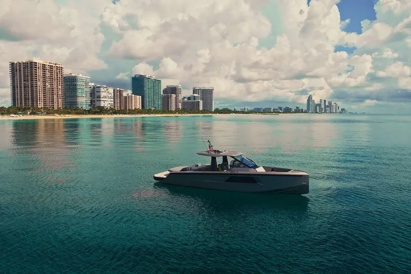 Slide: The Image of 2024 Maori 46ft yacht cruising near a city skyline on calm waters. - 17