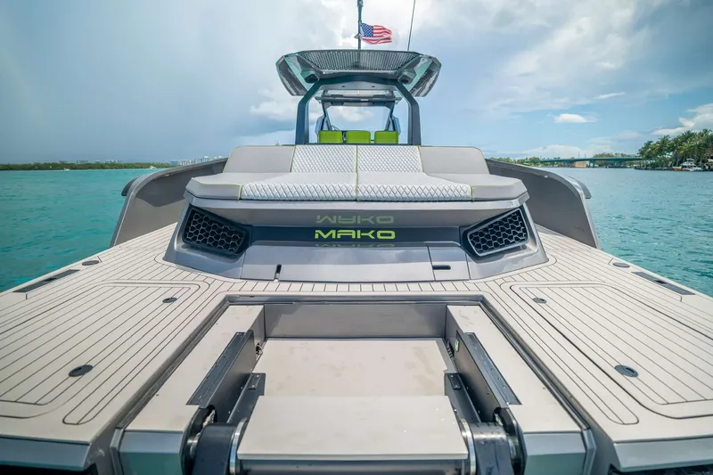 Slide: The Image of 2024 Maori 46ft yacht with sleek design on turquoise water, featuring modern deck and seating. - 32