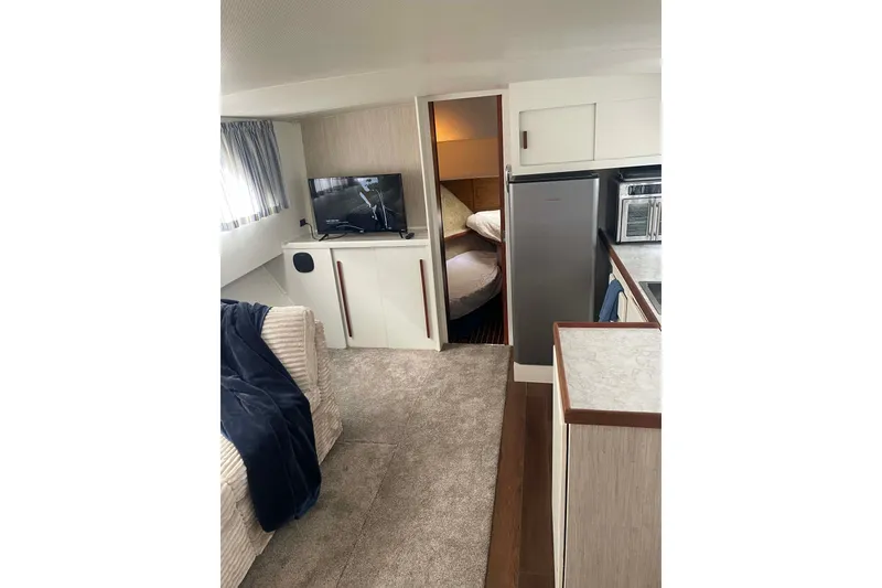Slide: The Image of Interior of 1974 Chris-Craft 350 Catalina yacht with cozy living area and modern amenities. - 3