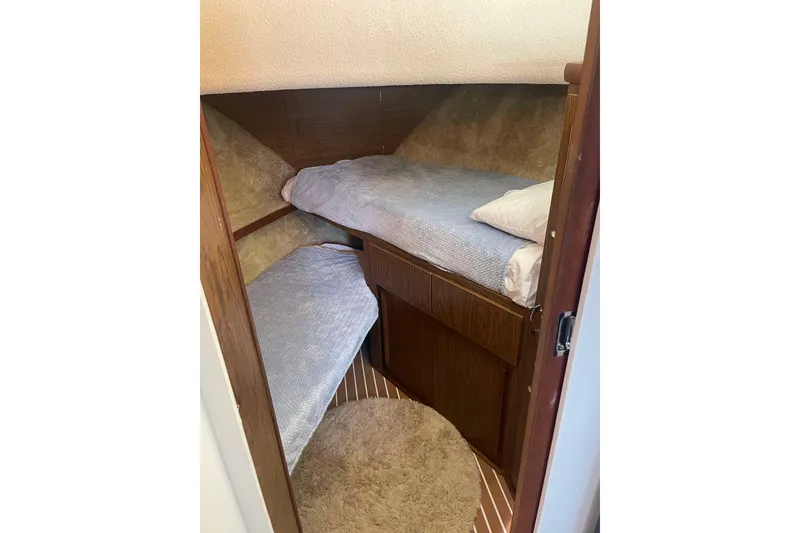 Slide: The Image of Cozy cabin interior of 1974 Chris-Craft 350 Catalina with twin beds and wooden accents. - 6