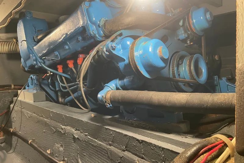 Slide: The Image of Engine of a 1974 Chris-Craft 350 Catalina, showcasing blue components and belts. - 12