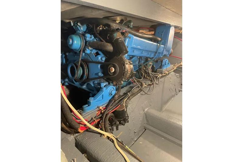 Slide: The Image of 1974 Chris-Craft 350 Catalina engine compartment with visible blue engine components. - 9
