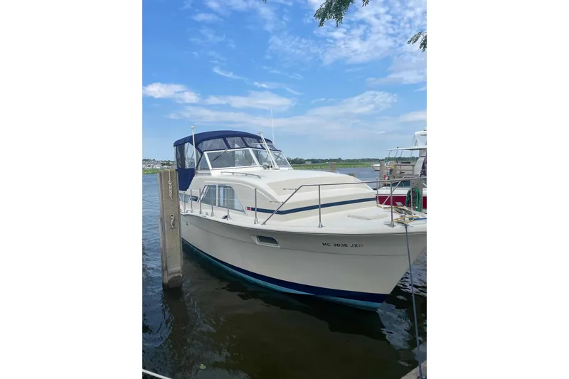 The Image of 1974 Chris-Craft 350 Catalina docked on a sunny day with blue skies. - 0