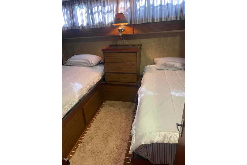 Slide: The Image of Cozy cabin interior of 1974 Chris-Craft 350 Catalina with twin beds and wooden furnishings. - 7