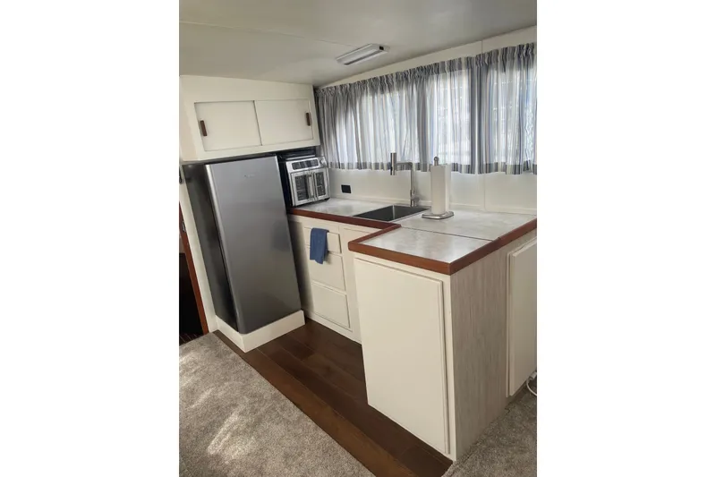 Slide: The Image of 1974 Chris-Craft 350 Catalina kitchen with modern appliances and sleek design. - 4